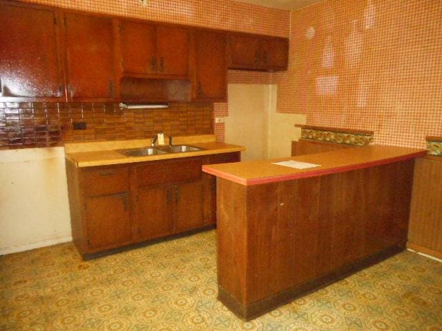 219 N Wilke Rd, Arlington Heights, IL 60005 - kitchen featuring decorative backsplash, brown cabinets, and light countertops