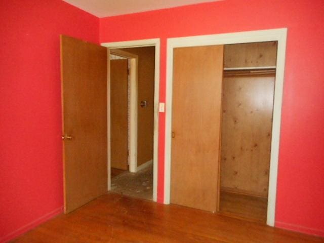 219 N Wilke Rd, Arlington Heights, IL 60005 - unfurnished bedroom featuring a closet and wood finished floors
