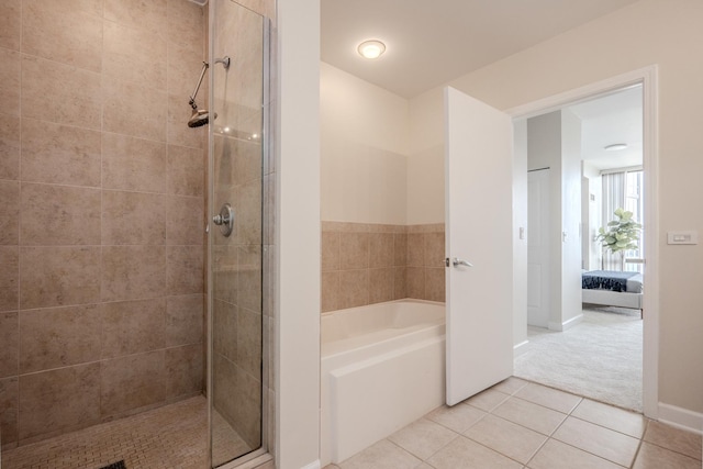 233 E 13th St Unit 2001, Chicago, IL 60605 - ensuite bathroom featuring a garden tub, a tile shower, and tile patterned floors