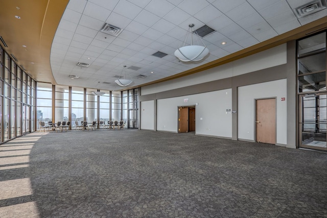 233 E 13th St Unit 2001, Chicago, IL 60605 - carpeted empty room with a high ceiling, a paneled ceiling, and expansive windows