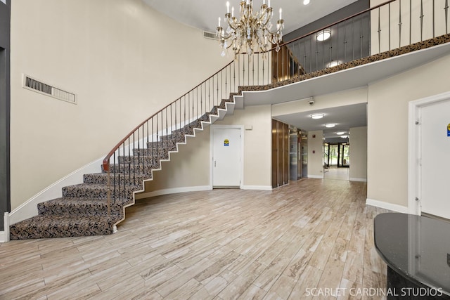190 S Wood Dale Rd Unit 406, Wood Dale, IL 60191 - foyer with a high ceiling, stairs, wood finished floors, and a chandelier