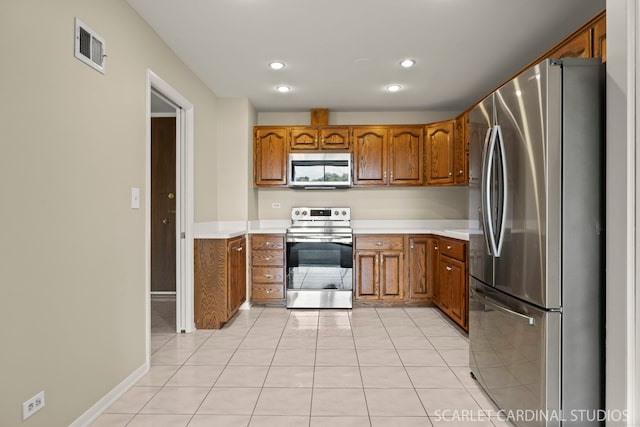 190 S Wood Dale Rd Unit 406, Wood Dale, IL 60191 - kitchen with stainless steel appliances, brown cabinetry, light countertops, light tile patterned flooring, and recessed lighting