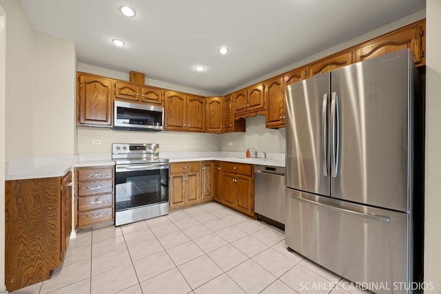 190 S Wood Dale Rd Unit 406, Wood Dale, IL 60191 - kitchen featuring stainless steel appliances, brown cabinets, recessed lighting, light tile patterned floors, and light countertops