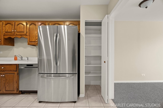 190 S Wood Dale Rd Unit 406, Wood Dale, IL 60191 - kitchen with appliances with stainless steel finishes, brown cabinets, light tile patterned flooring, and light countertops