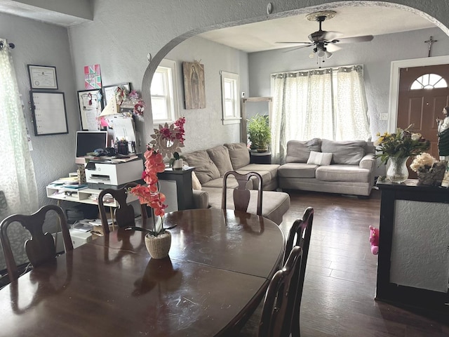 109 Seminary Ave, Aurora, IL 60505 - dining space with arched walkways, a textured wall, dark wood-type flooring, and ceiling fan