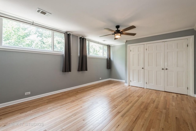 806 S May St, Chicago, IL 60607 - unfurnished bedroom with light wood-style flooring, crown molding, a closet, and a ceiling fan