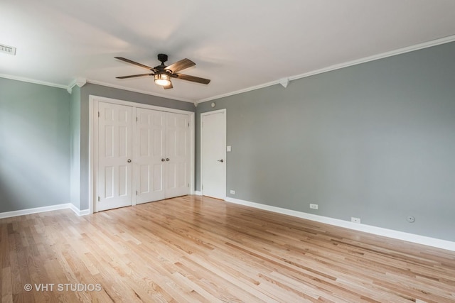 806 S May St, Chicago, IL 60607 - unfurnished bedroom featuring crown molding, light wood-style floors, ceiling fan, and a closet