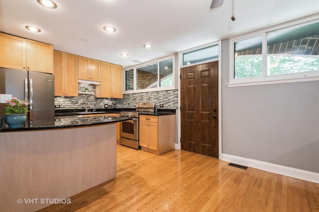 806 S May St, Chicago, IL 60607 - kitchen with stainless steel appliances, light wood finished floors, healthy amount of natural light, light brown cabinetry, and recessed lighting
