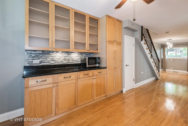806 S May St, Chicago, IL 60607 - kitchen with stainless steel microwave, backsplash, light wood-type flooring, and ceiling fan