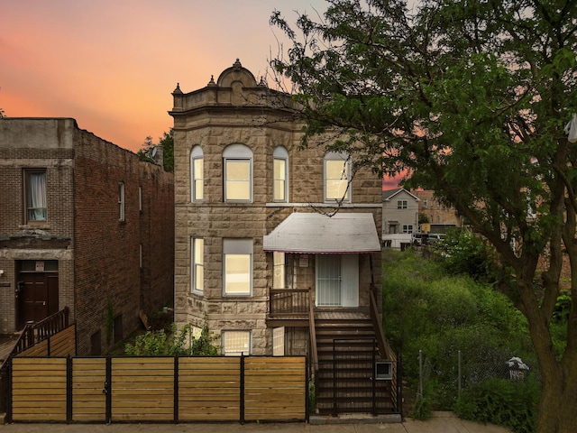 1532 S Homan Ave, Chicago, IL 60623 - view of front of home featuring a fenced front yard, stone siding, and stairs