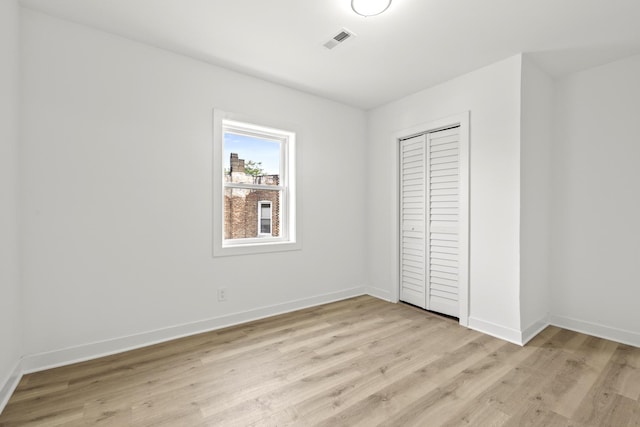 1532 S Homan Ave, Chicago, IL 60623 - unfurnished bedroom with light wood-type flooring and a closet