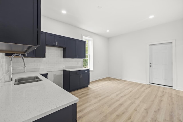 1532 S Homan Ave, Chicago, IL 60623 - kitchen with light stone countertops, backsplash, light wood-style floors, and recessed lighting