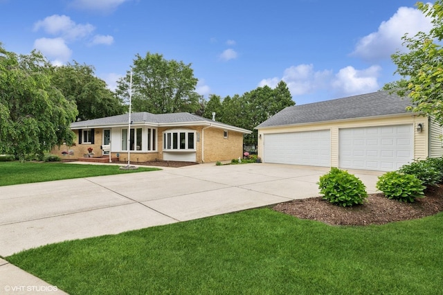 200 E Park Ave, Bloomingdale, IL 60108 - ranch-style house with brick siding, concrete driveway, and a front yard