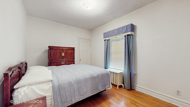 3120 N Natoma Ave, Chicago, IL 60634 - bedroom featuring radiator heating unit and wood finished floors