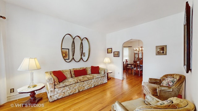 3120 N Natoma Ave, Chicago, IL 60634 - living area featuring arched walkways, wood finished floors, and a chandelier