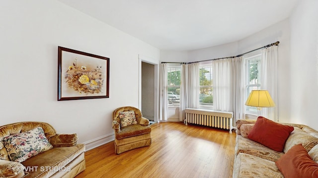 3120 N Natoma Ave, Chicago, IL 60634 - living area featuring radiator heating unit and wood finished floors