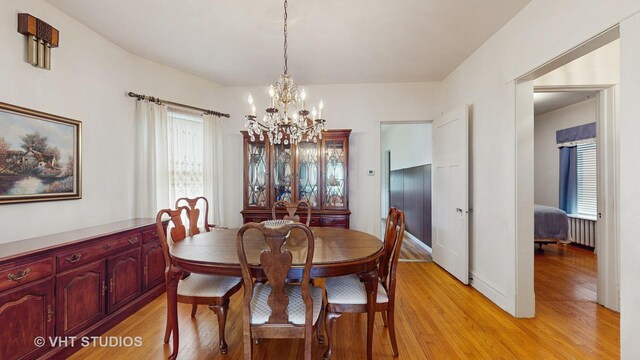 3120 N Natoma Ave, Chicago, IL 60634 - dining space with a chandelier, light wood finished floors, and radiator