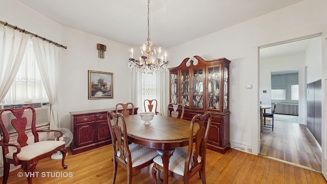 3120 N Natoma Ave, Chicago, IL 60634 - dining area with radiator, a chandelier, and light wood-type flooring
