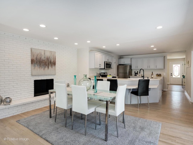 622 Pleasant Pl, Streamwood, IL 60107 - dining area with light wood finished floors, recessed lighting, and a brick fireplace