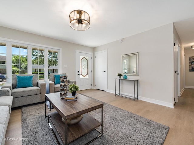 622 Pleasant Pl, Streamwood, IL 60107 - living room featuring light wood-type flooring and a chandelier
