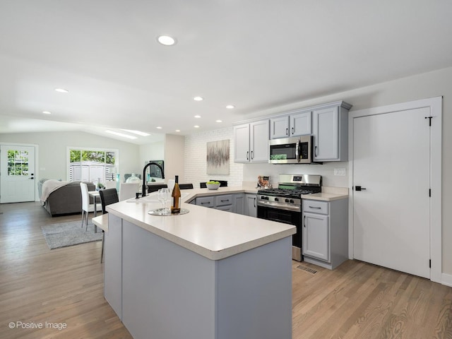 622 Pleasant Pl, Streamwood, IL 60107 - kitchen featuring stainless steel appliances, gray cabinetry, light countertops, light wood finished floors, and recessed lighting