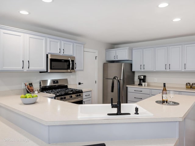 622 Pleasant Pl, Streamwood, IL 60107 - kitchen featuring appliances with stainless steel finishes, light countertops, recessed lighting, and a peninsula