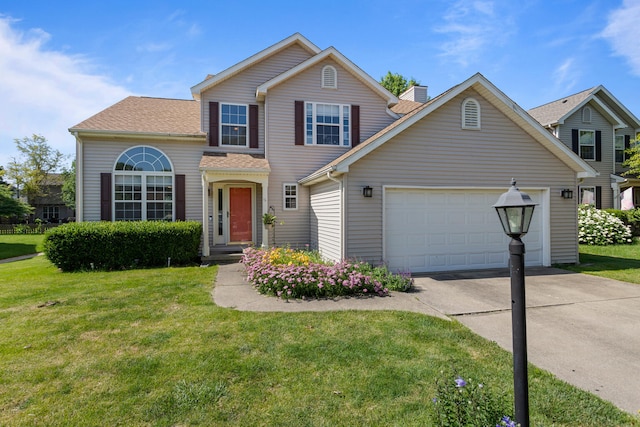 601 E Tomaras Ave, Savoy, IL 61874 - traditional-style house featuring concrete driveway, a front yard, a garage, and roof with shingles