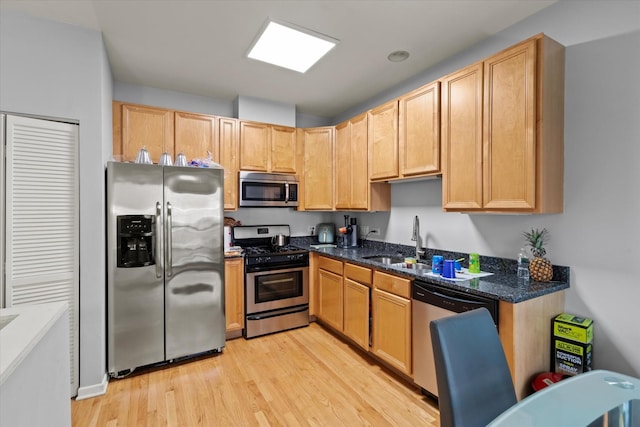 4518 S Woodlawn Ave Unit 4518, Chicago, IL 60653 - kitchen with stainless steel appliances, light wood-style floors, dark stone counters, and light brown cabinetry