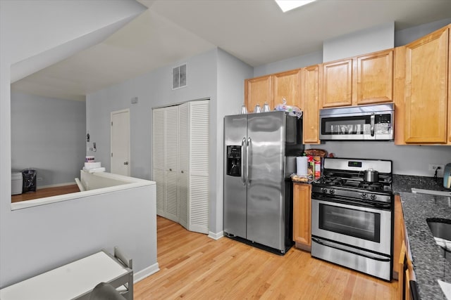 4518 S Woodlawn Ave Unit 4518, Chicago, IL 60653 - kitchen featuring stainless steel appliances, light wood-style floors, dark stone countertops, and light brown cabinets