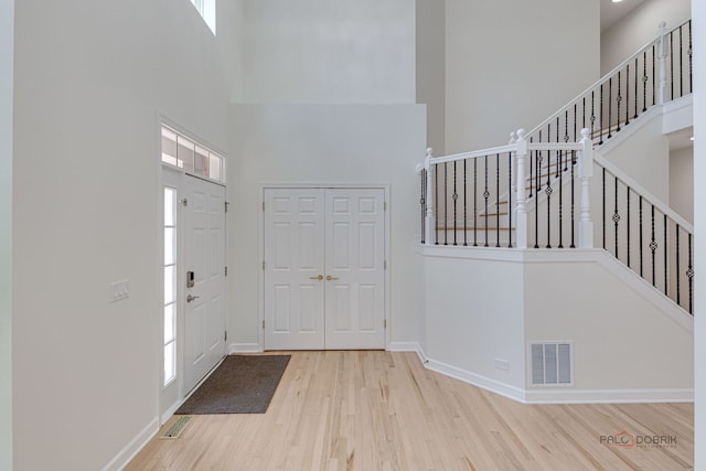 5860 Betty Gloyd Dr, Hoffman Estates, IL 60192 - entryway featuring a high ceiling, wood finished floors, and stairs