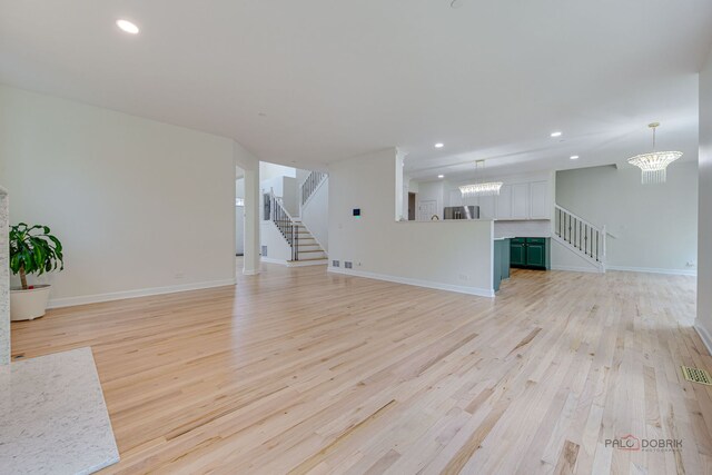 5860 Betty Gloyd Dr, Hoffman Estates, IL 60192 - unfurnished living room featuring stairway, light wood-type flooring, a chandelier, and recessed lighting
