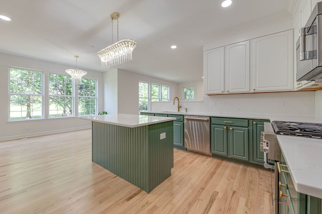 5860 Betty Gloyd Dr, Hoffman Estates, IL 60192 - kitchen with green cabinets, appliances with stainless steel finishes, a chandelier, white cabinets, and light wood finished floors