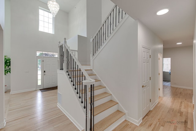5860 Betty Gloyd Dr, Hoffman Estates, IL 60192 - entryway with healthy amount of natural light, wood finished floors, stairway, and a towering ceiling