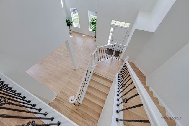 5860 Betty Gloyd Dr, Hoffman Estates, IL 60192 - staircase featuring wood finished floors and a high ceiling