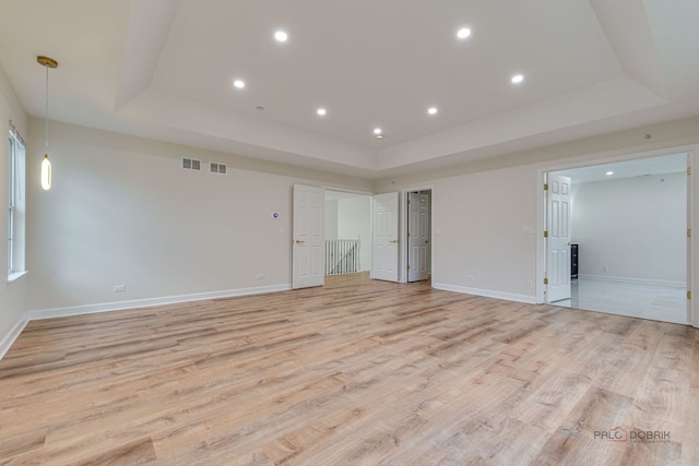 5860 Betty Gloyd Dr, Hoffman Estates, IL 60192 - spare room featuring a tray ceiling, light wood finished floors, and recessed lighting