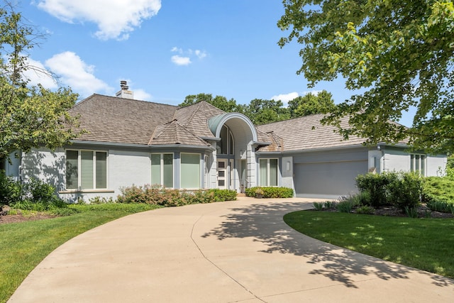 1670 Jasmine Ct, Highland Park, IL 60035 - view of front of property featuring brick siding, concrete driveway, a chimney, an attached garage, and a front yard