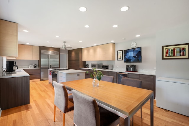 1670 Jasmine Ct, Highland Park, IL 60035 - kitchen featuring modern cabinets, appliances with stainless steel finishes, wine cooler, a center island, and recessed lighting