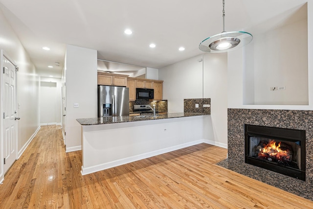 1917 S State St Unit 1, Chicago, IL 60616 - kitchen with stainless steel appliances, a fireplace with flush hearth, a peninsula, light wood finished floors, and recessed lighting