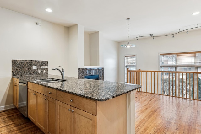 1917 S State St Unit 1, Chicago, IL 60616 - kitchen featuring dishwasher, a peninsula, dark stone countertops, light wood-style floors, and decorative backsplash