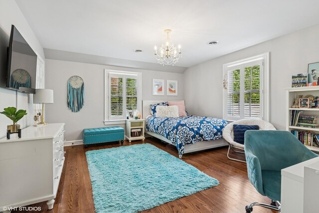 423 S Beverly Ln, Arlington Heights, IL 60005 - bedroom with multiple windows, a chandelier, and wood finished floors