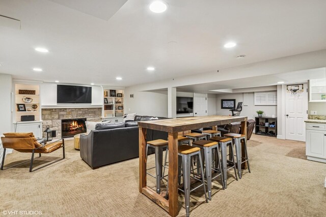 423 S Beverly Ln, Arlington Heights, IL 60005 - living area featuring light carpet, recessed lighting, a bar, and a stone fireplace