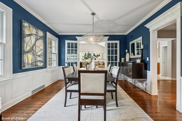423 S Beverly Ln, Arlington Heights, IL 60005 - dining space with dark wood-style flooring, a chandelier, ornamental molding, and a wainscoted wall