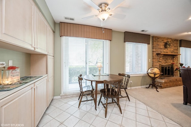 601 Lake Hinsdale Dr Unit 104, Willowbrook, IL 60527 - dining area with ceiling fan, light carpet, a brick fireplace, and light tile patterned floors