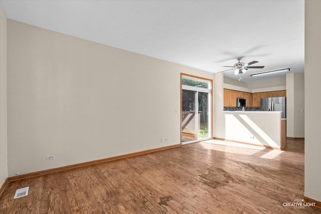 2825 Rebecca Ct W, Montgomery, IL 60538 - unfurnished living room featuring light wood finished floors and a ceiling fan