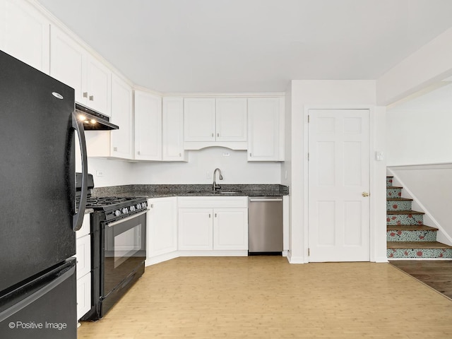 118 Burlington Ave, Clarendon Hills, IL 60514 - kitchen with black appliances, light wood-style floors, under cabinet range hood, white cabinets, and dark stone counters