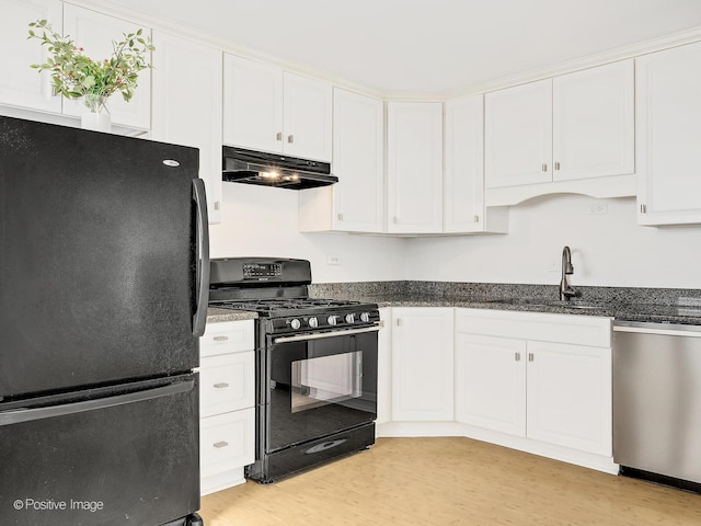 118 Burlington Ave, Clarendon Hills, IL 60514 - kitchen with black appliances, under cabinet range hood, white cabinetry, light wood finished floors, and dark stone countertops