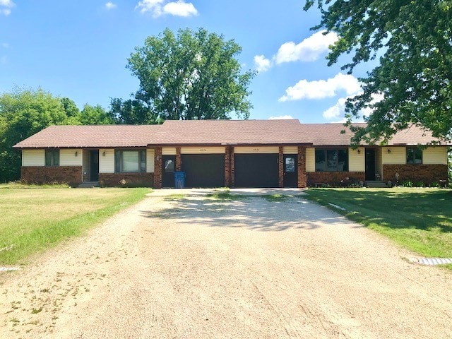 29176 Terra Vista Dr, Rock Falls, IL 61071 - ranch-style home featuring an attached garage, driveway, brick siding, and a front lawn