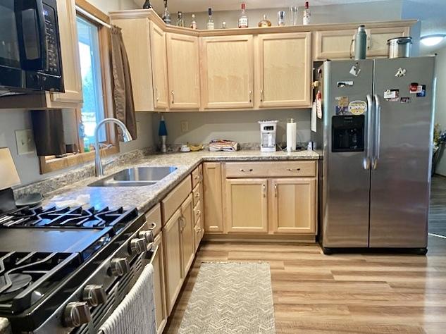 29176 Terra Vista Dr, Rock Falls, IL 61071 - kitchen featuring stainless steel appliances, light wood-type flooring, and light brown cabinetry