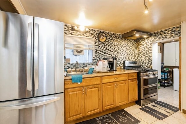 6612 N Mozart St, Chicago, IL 60645 - kitchen featuring appliances with stainless steel finishes, wall chimney range hood, decorative backsplash, light tile patterned floors, and light countertops