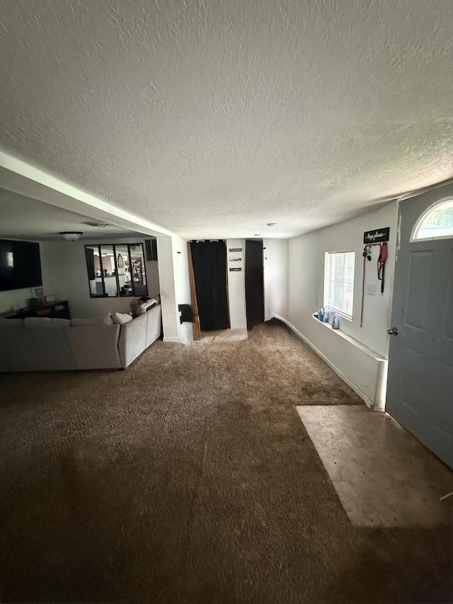 24041/2 W John St, Champaign, IL 61820 - unfurnished living room featuring a textured ceiling and carpet